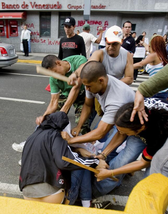 Journalists from newspaper Ultimas Noticias are attacked during a protes...